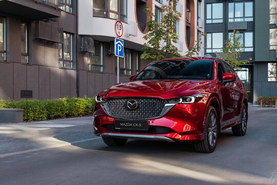 Kyiv, Ukraine -September 2025: Red car Mazda CX-5 in residential district at sunny day