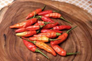 Fresh Red Cayenne pepper on a wooden cutting board, Stack of vegetables. 