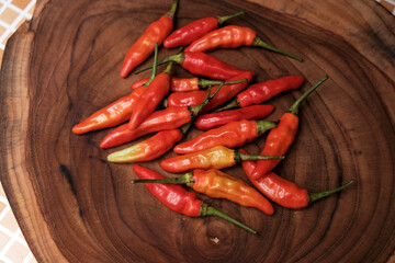 Fresh Red Cayenne pepper on a wooden cutting board, Stack of vegetables. 