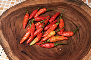 Fresh Red Cayenne pepper on a wooden cutting board, Stack of vegetables. 