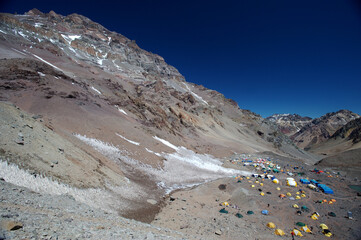 A tent camp set up on the slopes of snowy mountains in winter for climbers, tourists, mountaineers, and scientists
