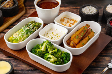 Assorted side dishes and garnishes served in small bowls