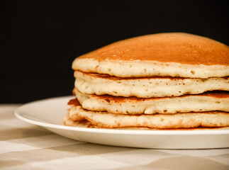 A stack of five golden brown pancakes