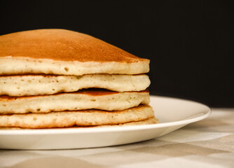 A stack of five golden brown pancakes