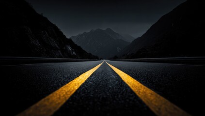 Dark, empty road stretching to mountains