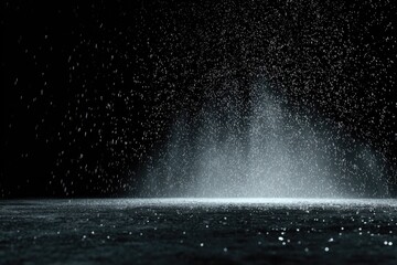 Dramatic shot of water droplets illuminated against a dark background, creating an abstract effect