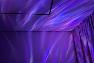 Projector colorful light reflections dance across a purple wall and ceiling, creating an enchanting atmosphere in a cozy room with soft curtains and modern decor elements