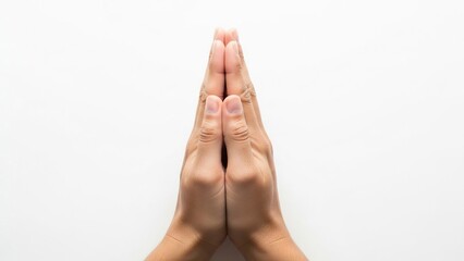 Hands pressed together in a praying gesture set against a neutral background