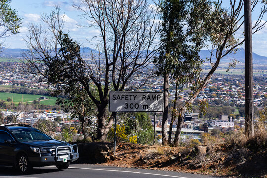 safety ramp 300m sign beside road on steep descent