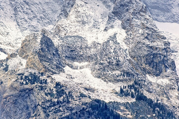 Rock face on a mountain with new fresh snow