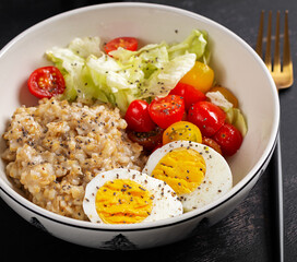 Healthy breakfast. Bowl of oatmeal and fresh vegetables and boiled egg.