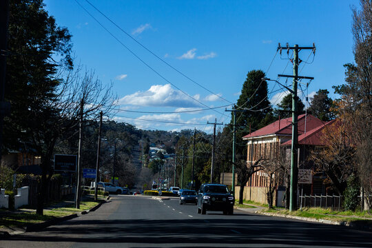 Cars driving along road from roundabout