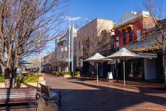 Sunlit Armidale streetscape with shade umbrellas for cafe seats