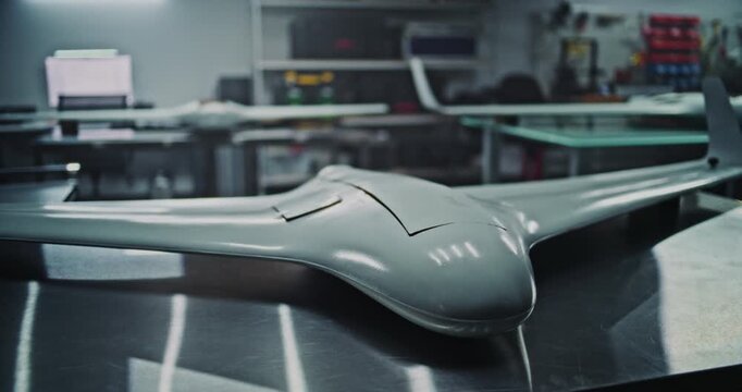 Production Line Displaying Finished Defense Unmanned Vehicles. Industrial Wide Shot of Several Finished Defense Unmanned Vehicles Ready For Inspection. Scale and Organization of High Tech Factory.