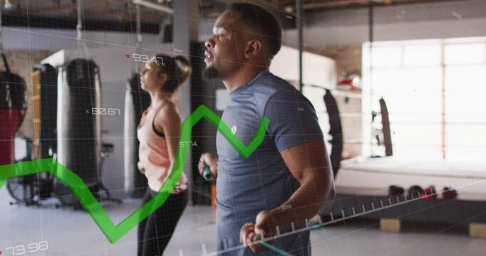 Workout pair gripping jump-ropes and skipping in gym, waveforms syncing jumps for cardio interval