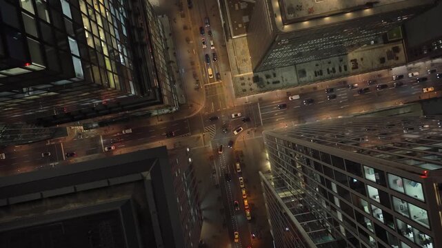 Aerial shot flying through fog over skyscrapers and traffic in the financial district of Frankfurt am Main at night depict life in a modern european metropolis