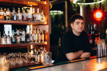 Bartender Leaning Against Bar Counter in a Modern Bar Setting
