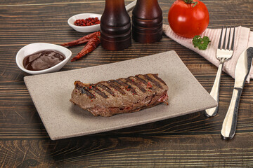 Grilled beef striploin steak with sauce