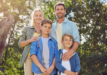 Fototapeta premium Portrait, parents or children in forest with smile, love or bonding together on summer break. Happy, family or people in nature with trust, connection or healthy relationship in spring vacation.