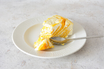 Delicious Marbled Cheesecake Slice on a White Plate with a teaspoon