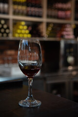 Red wine glass standing on bar counter