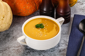 Vegan pumpkin cream soup served sesam