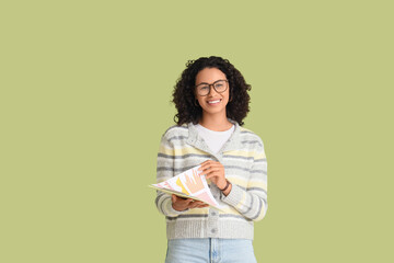 Young African-American woman with diagrams on green background