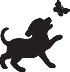 A playful puppy attempts to catch a butterfly in silhouette