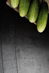 Still Life of fresh cucumbers on a wooden table