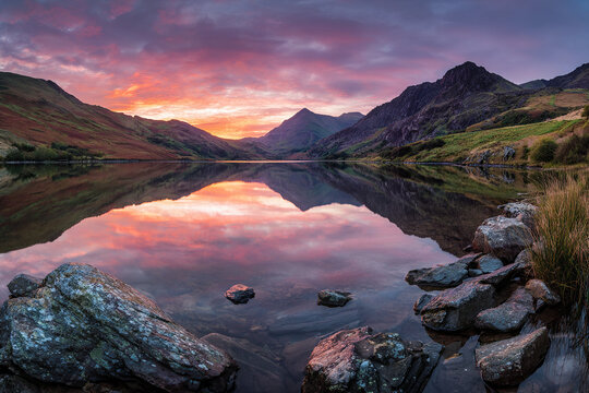 Breathtaking sunrise over a serene mountain lake with colorful reflections - Powered by Adobe