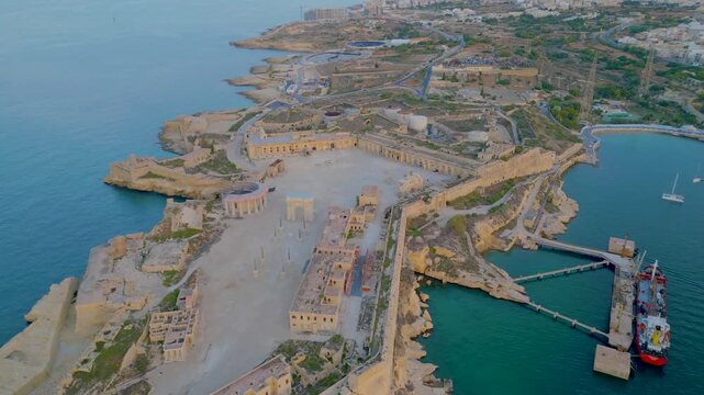 Malta Fort Ricasoli historic knight bastions in Grand Harbour entrance aerial drone view.

