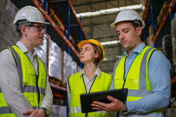 Blue collar workers are working at warehouse.