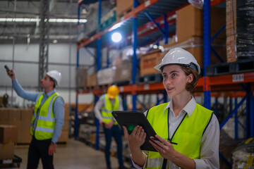 Blue collar workers are working at warehouse.