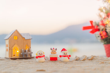Santa Claus Doll Cute and Christmas Tree House Relaxing on the Beach. Merry Christmas Holiday. Bright Background. Patong Beach, Phuket, Thailand.