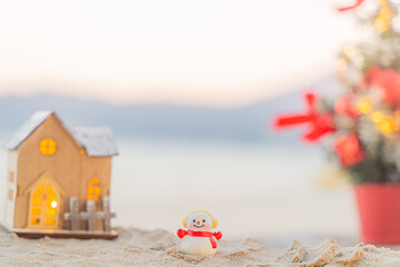 Santa Claus Doll Cute and Christmas Tree House Relaxing on the Beach. Merry Christmas Holiday. Bright Background. Patong Beach, Phuket, Thailand.
