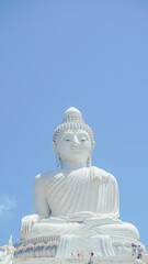 Phuket Big Buddha statue. afternoon light sky and blue ocean are on the back of white Phuket big Buddha is the one of landmarks on Phuket island Thailand.