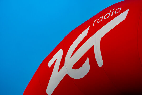 Radio ZET promotional balloon against clear blue sky