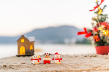 Santa Claus Doll Cute and Christmas Tree House Relaxing on the Beach. Merry Christmas Holiday. Bright Background. Patong Beach, Phuket, Thailand.