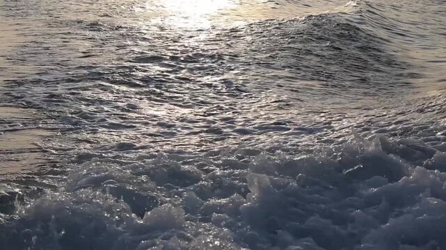 Ocean waves with swirling sea foam, captured from a ship&rsquo;s deck, showcasing the dynamic beauty of the open sea