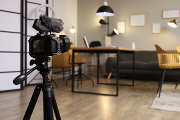 Interior of recording studio with workplace, sofa and glowing lamps on camera screen, closeup