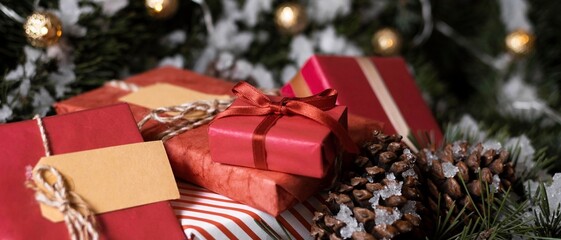 Christmas gifts and decorations with pinecones and lights on a festive background