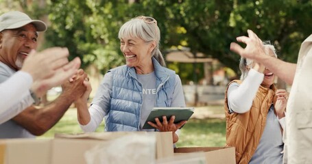 Volunteer, tablet and people in park, high five and community service with celebration. Mature group, outdoor and applause with social responsibility, success and app for charity project and donation