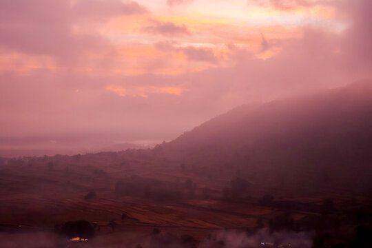 Scenic landscape of forested mountain ridges during sunrise. Layer of mist or fog at Araku hill station.