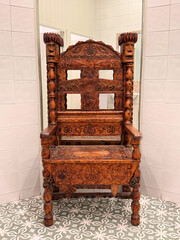 old hand carved wooden chair in a room