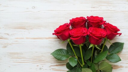 Bunch of red roses lying on a light colored wooden background