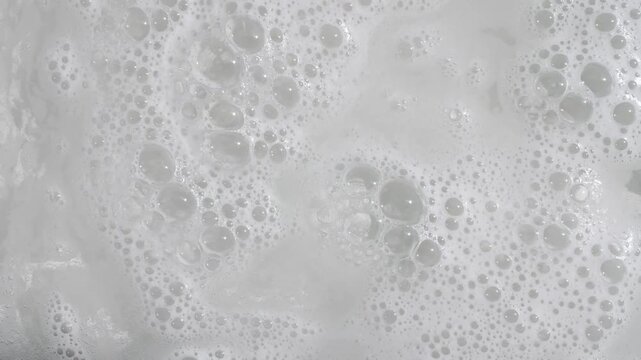 Bubbles of White Soap Foam Bathtup. Macro Structure Soap Foam close-up. Natural Shampoo Bubbles Motion. Cleanliness, Cleaning Concept, Laundry, Shower. . High quality 4k footage