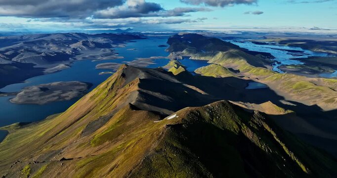 A massive IMAX-style dolly-right sweep over Iceland&rsquo;s razorback ridge, unveiling deep blue lakes, fractured valleys and towering highlands in an ultra-epic, hyper-cinematic reveal.