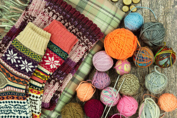 Knitted socks and knitting yarn. Warm, colorful socks for fall and winter made from yarn. Knitting is a form of handicraft.