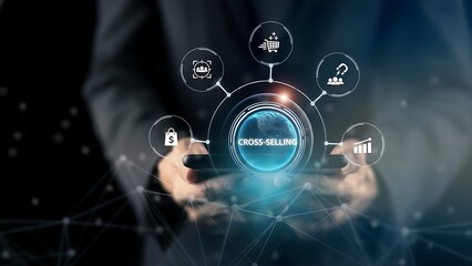 A businessman uses augmented reality display to demonstrate cross-selling strategy. Illustrating the interconnected nature of business data and digital interface in a modern professional setting.