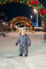 A cheerful young boy playing outside on New Year’s Eve